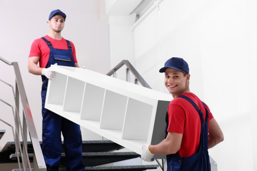 Removal team preparing items with safety equipment during a house move