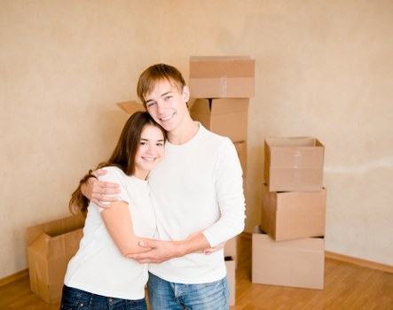 Unpacking boxes in a new home after a move in Sutton